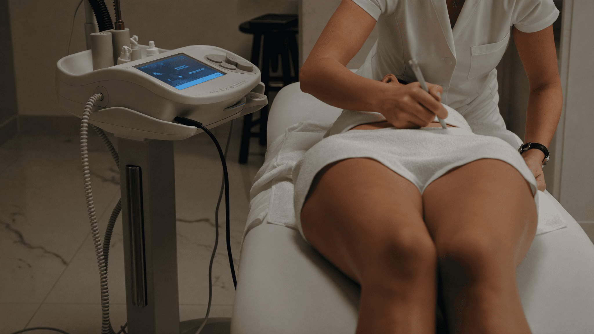 Practitioner preparing a treatment room in a premium aesthetics clinic