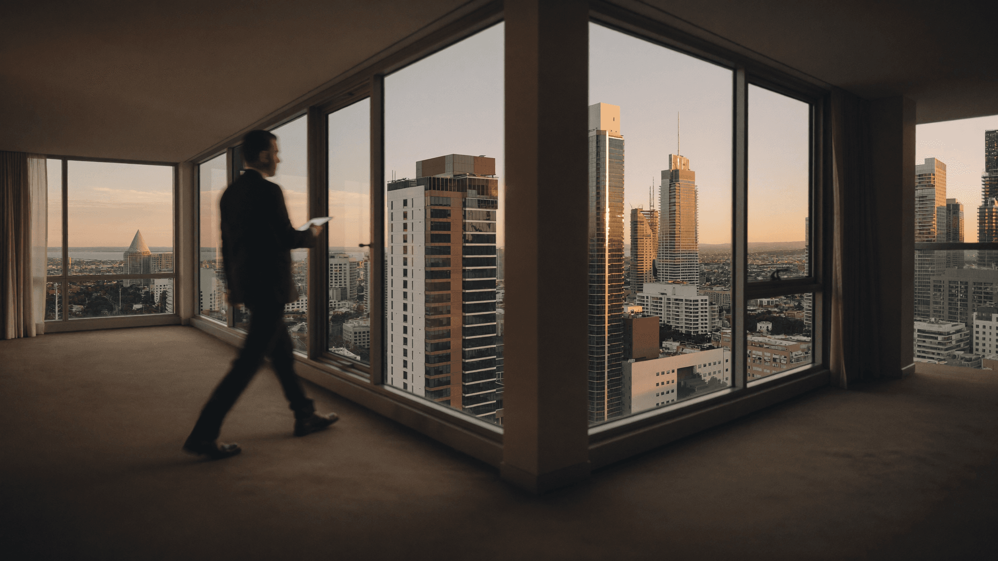 Melbourne property manager with a tablet inspecting a modern apartment with city skyline views