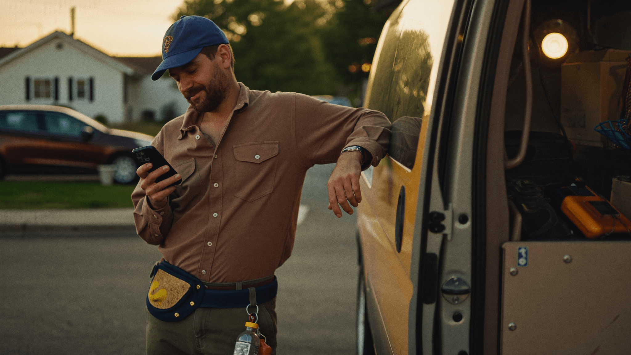 Business owner checking confirmed bookings on his phone while out on a job